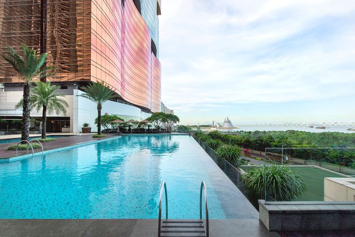 Infinity-style outdoor pool at MGM MACAU with waterfront views, complementing a luxury spa and wellness stay in Macau.