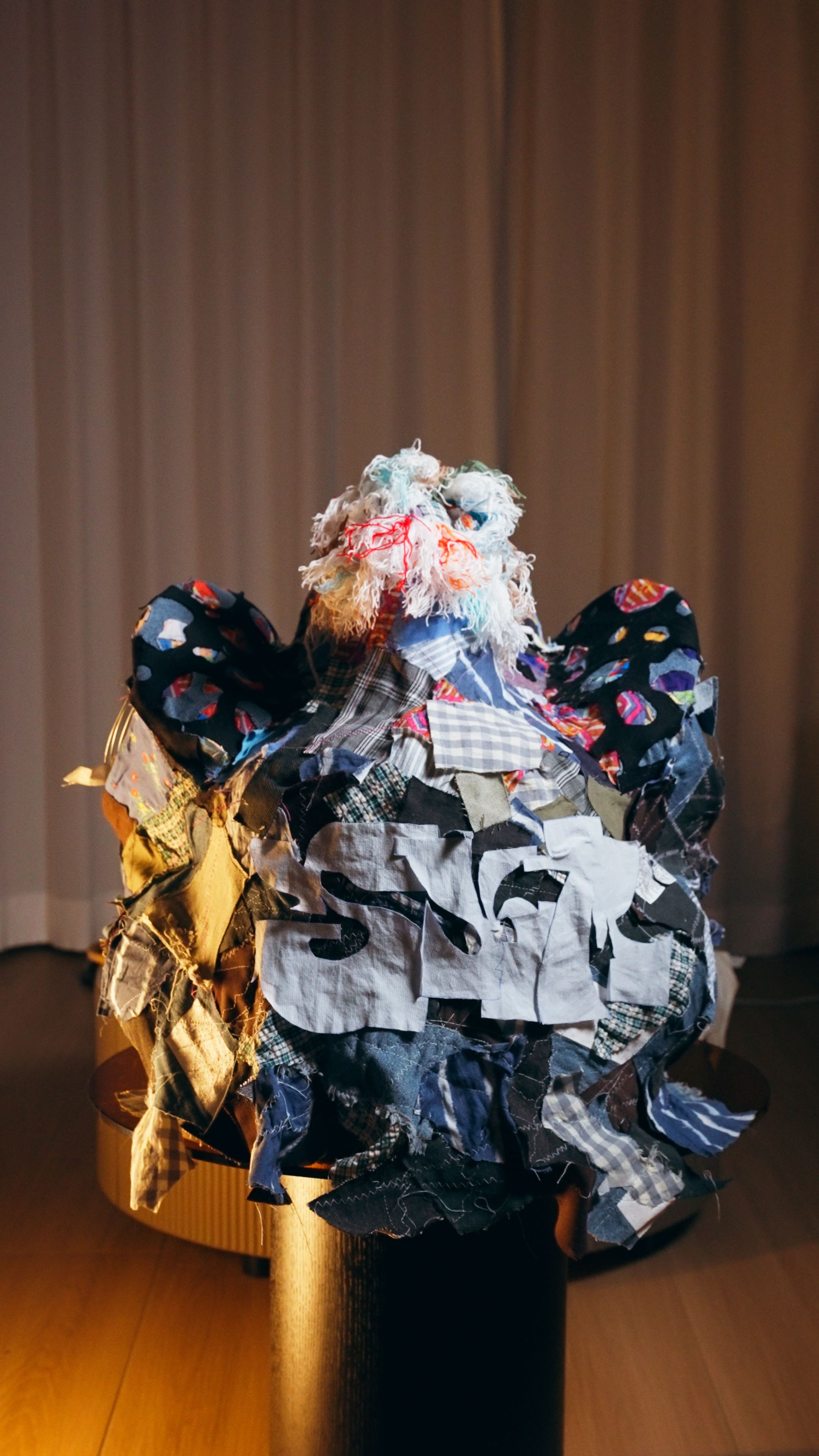 Nicole Ng’s artwork Fabric of Heritage: A New Geometric Chapter reinterprets a lion dance figure using recycled garments and patchwork, blending sustainability, Lingnan culture, and contemporary art.