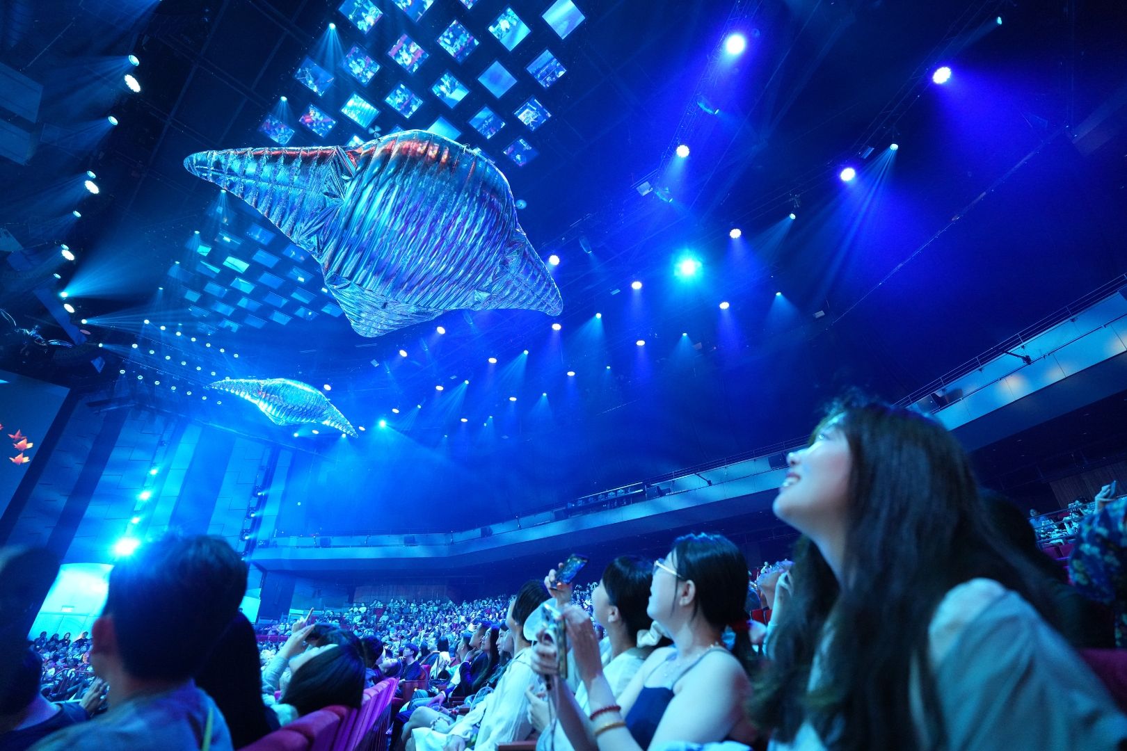 Audience members watch Macau 2049 at MGM Theater in MGM COTAI as large-scale digital whale installations glide above the stage, combining immersive technology with innovative theatrical storytelling.