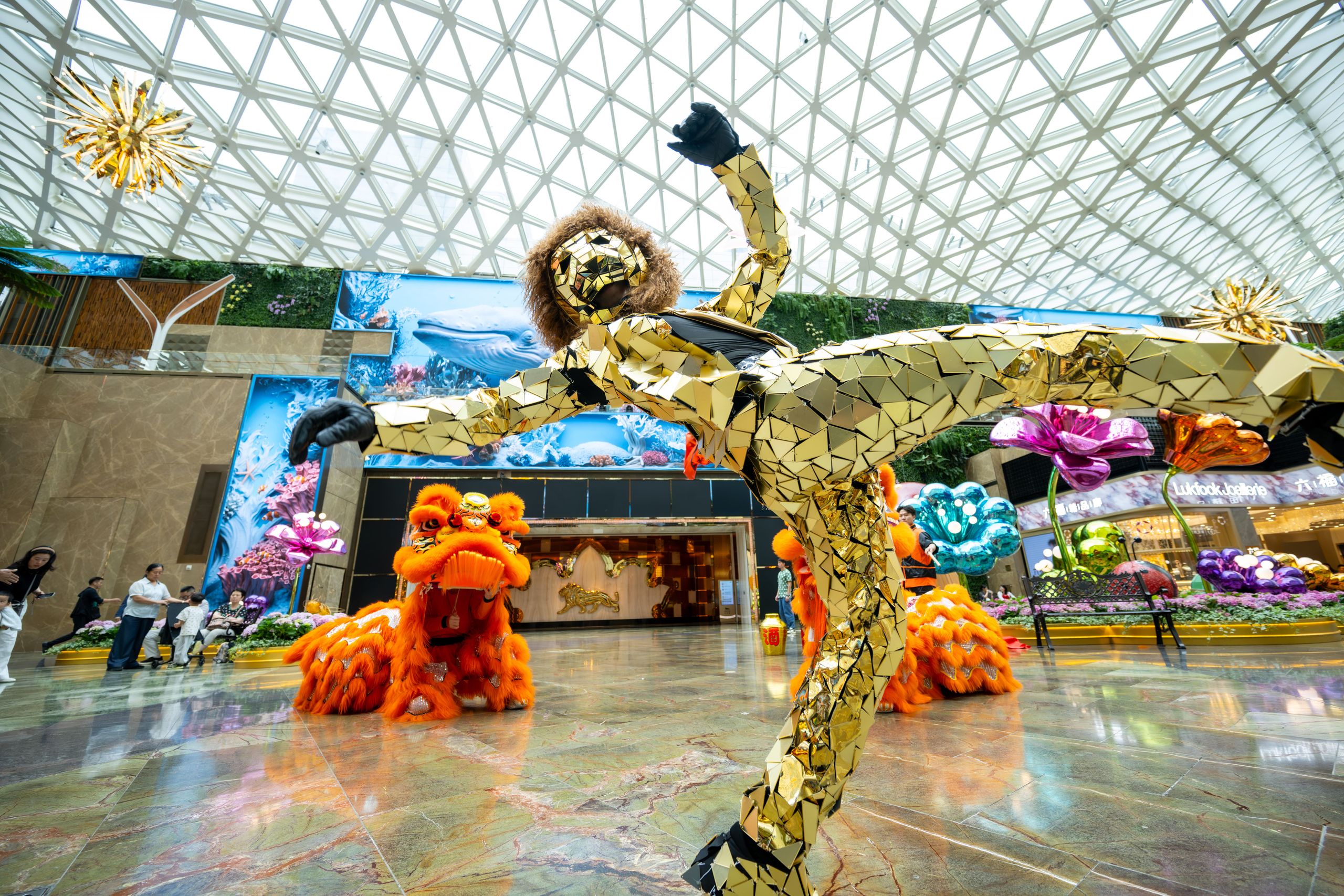 Lion Dance Performance presented by Macau 2049 at MGM Cotai's Spectacle, featuring a performer in a gold mirrored costume and traditional lion dance during Golden Week.